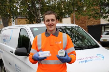 ANGLIAN WATER SMART METER ROLLOUT VAN  MAN HOLDING SMART METER