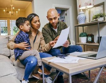 CUSTOMER BILLS young family reviewing paperwork