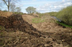 Illegally dumped waste on floodplain next to River Swale