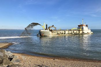 Shingle spraying by Sospan Dau to strengthen Pevseney Bay tidal defences